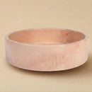 Pink ceramic bowl on a beige background
