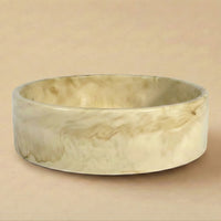 Marble-patterned ceramic bowl on a beige background