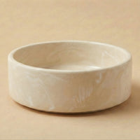 White ceramic bowl on a beige background