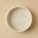 White ceramic bowl on a beige background