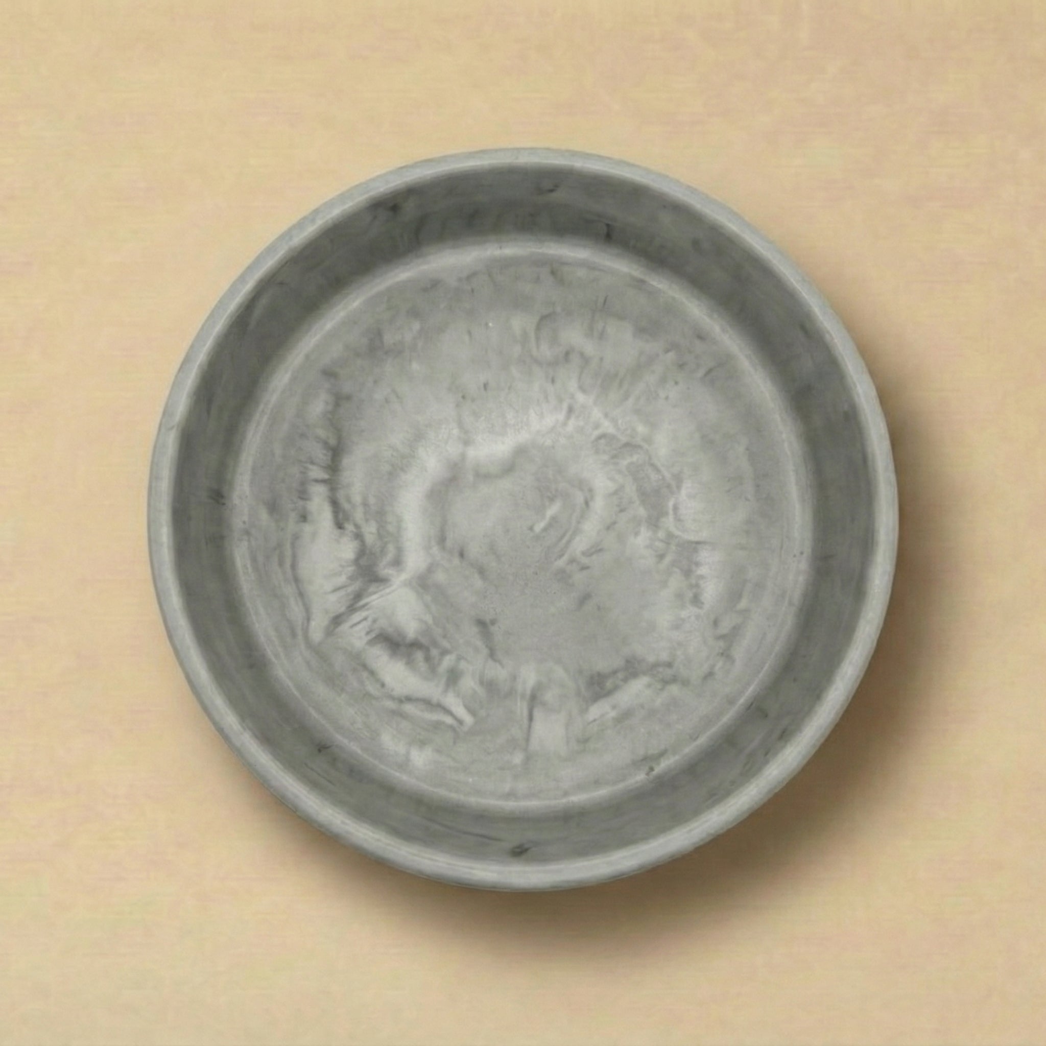 Gray ceramic bowl on a beige background