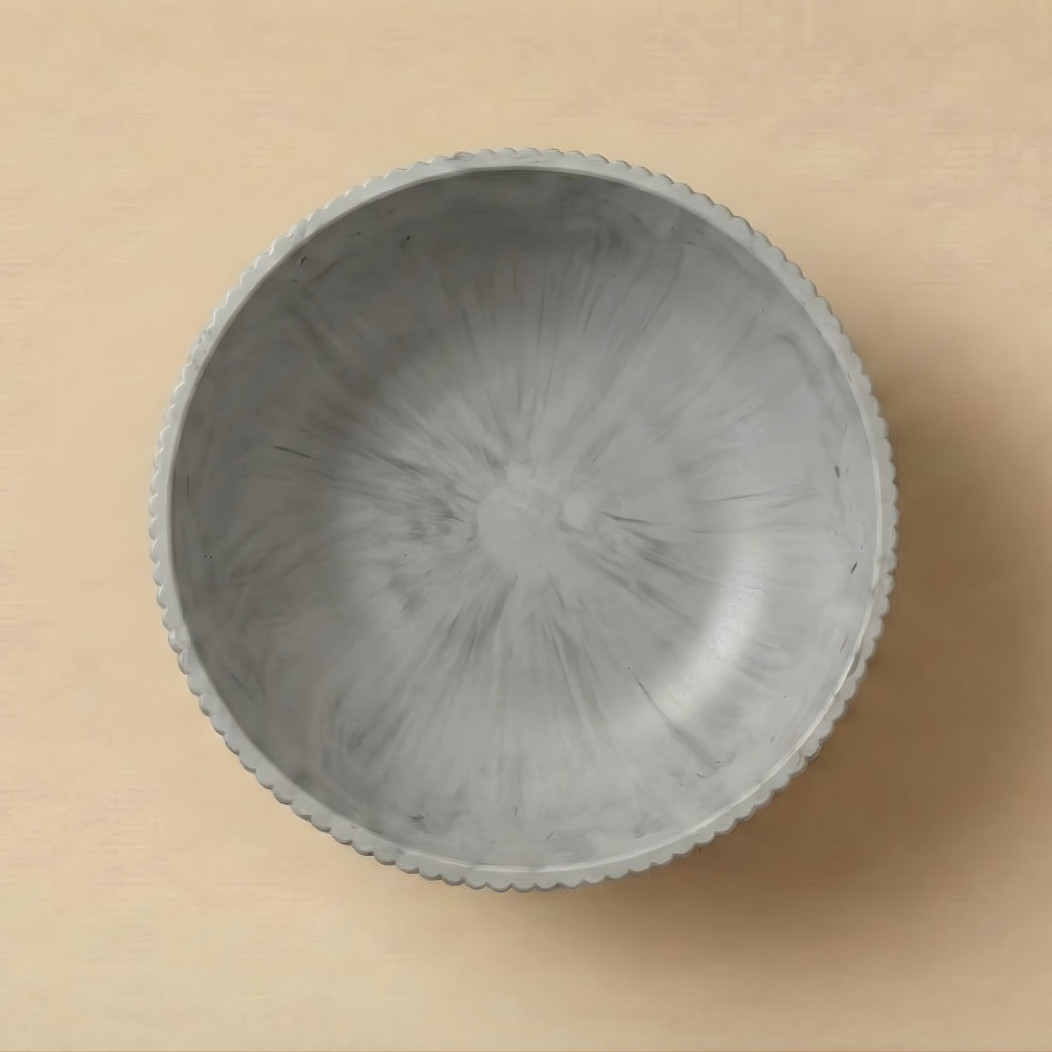 Gray textured bowl on a beige background