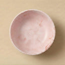 Pink lace-trimmed fabric on a beige background