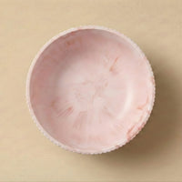 Pink lace-trimmed fabric on a beige background