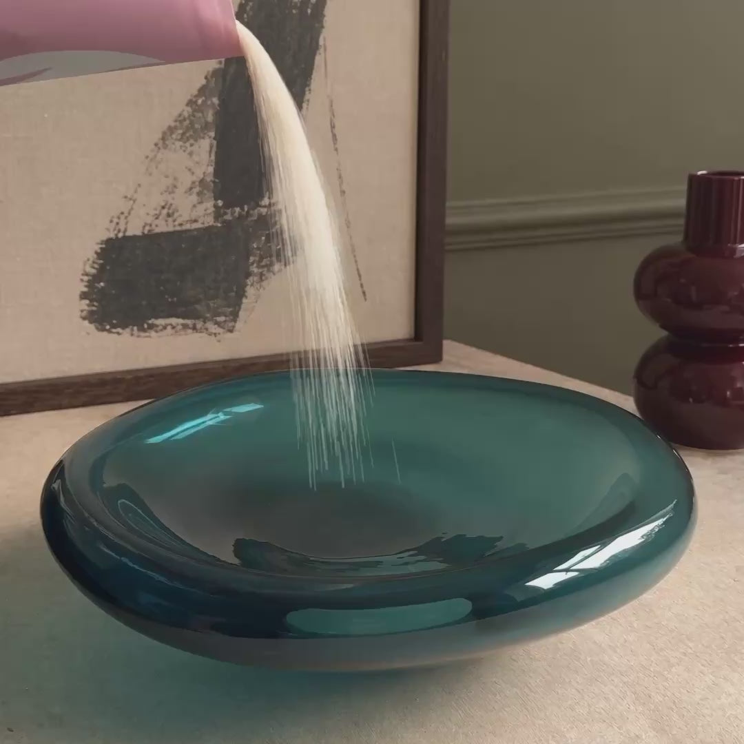Three wicks burning in pearled wax, each in its own small pool